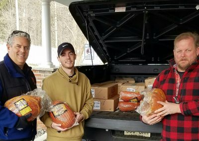 MLAA board members Darrell Fusco, Sean Dunn and Jamie Rodgers deliver hams to the Interfaith Food Pantry.